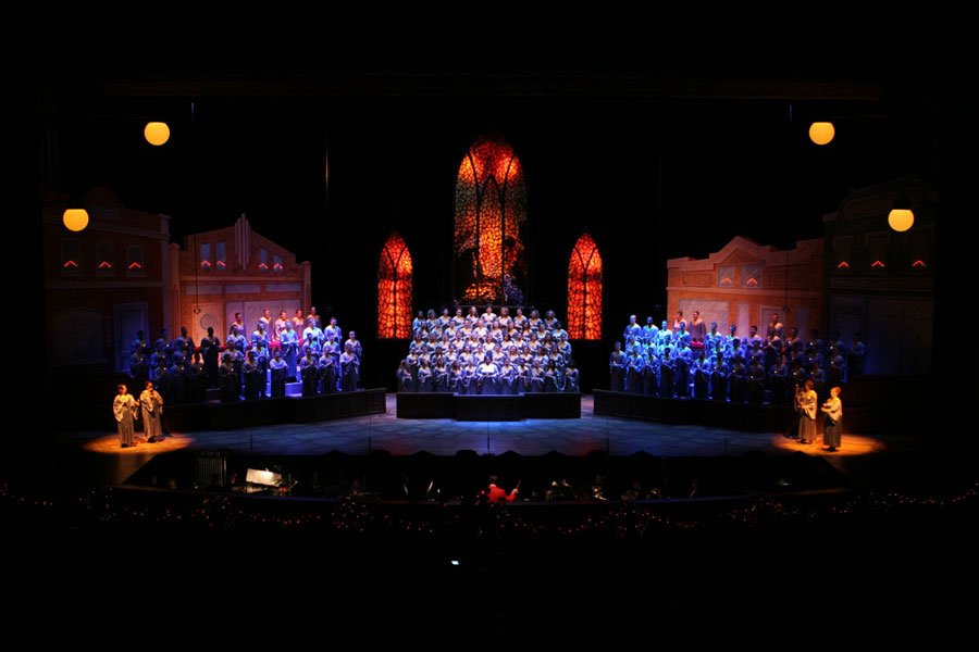 Cathedral and stained glass scenic design with amber and teal lighting at Elliott Hall
