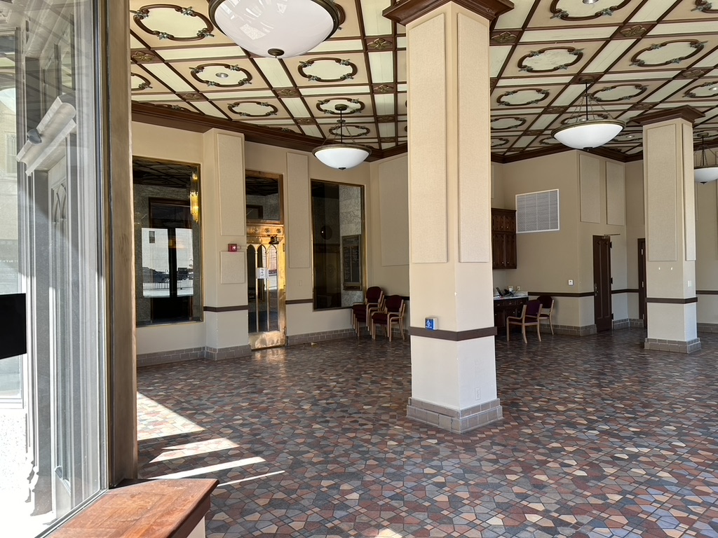 Original ornate tile floors, decorative ceiling medallions, and architectural detail inside the Depot